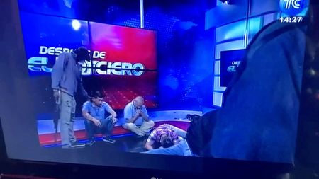 Ecuador TV studio taken over live on air by masked people brandishing guns