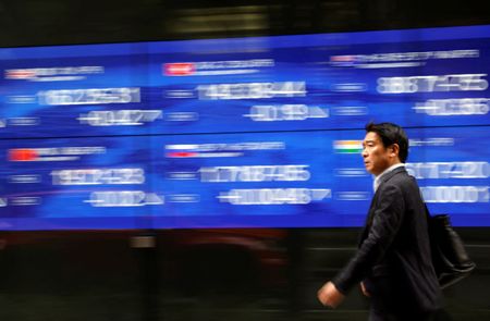 Nikkei soars to within sight of all-time peak, closes at 34-year high